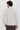 Man wearing light beige slim fit turtleneck sweater, back view, casual fashion