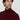 Man wearing a burgundy turtleneck sweater with a relaxed fit on a neutral background