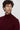 Man wearing a burgundy turtleneck sweater with a relaxed fit on a neutral background