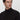 Man wearing a basic black turtleneck sweater with a relaxed fit, plain background