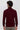 Back view of man wearing burgundy turtleneck sweater and beige trousers