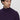 Man wearing a dark purple turtleneck sweater with a relaxed fit, close-up view