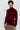 Man wearing a slim-fit burgundy turtleneck sweater and grey trousers