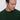 Man wearing a dark green crew neck sweater, relaxed fit, against a light background