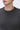 Close-up of a man wearing a dark grey crew neck knit sweater, relaxed fit