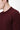 Close-up of a man wearing a burgundy crew neck knit sweater, relaxed fit.