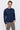 Man wearing a navy blue crew neck sweater and beige pants, casual fashion style