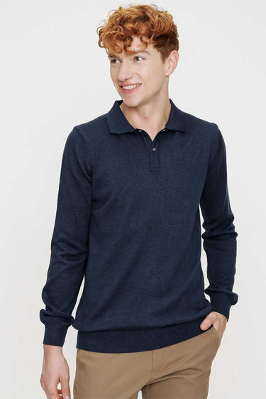Man wearing navy long sleeve polo shirt and tan trousers, relaxed fit, casual fashion