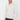 Man wearing a light beige long sleeve polo shirt with a relaxed fit, casual fashion style