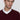 Man in a burgundy V-neck sweater with relaxed fit over a white collared shirt