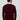 Man wearing a burgundy V-neck sweater and white collared shirt, back view, plain background