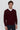 Man wearing a burgundy V-neck sweater over a white shirt, smart casual fashion