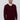Man wearing burgundy V-neck sweater over white shirt, relaxed fit, against plain background