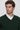 Man wearing a dark green V-neck sweater over a white dress shirt, relaxed fit.