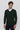 Man wearing dark green V-neck long sleeve sweater over white shirt, relaxed fit