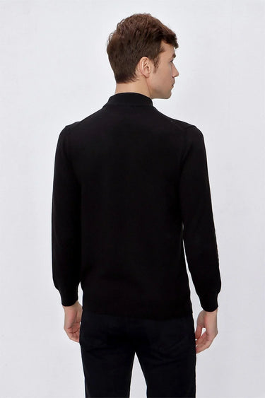 Man wearing black long sleeve knit sweater with relaxed fit, shown from the back