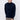 Man wearing a navy blue mock neck sweater and beige trousers against a plain background
