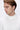 Man wearing a white relaxed fit mock neck sweater, close-up, minimal background