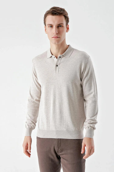 Man wearing a beige long sleeve polo shirt with relaxed fit, standing against white background