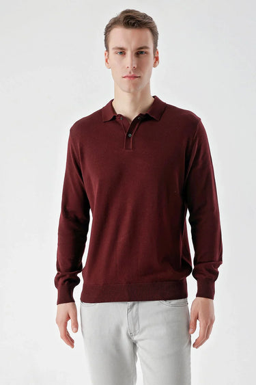 Man wearing a burgundy long sleeve polo shirt with relaxed fit and light grey trousers