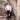 Man in white slim fit dress shirt and black trousers posing on stone steps