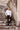 Man in white slim fit dress shirt and black trousers posing on stone steps