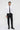 Man wearing slim fit white dress shirt, black slim trousers, black tie, and dress shoes