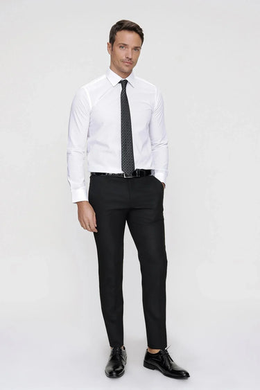 Man wearing slim fit white dress shirt, black slim trousers, black tie, and dress shoes