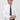 Man wearing white slim fit dress shirt, black polka dot tie, and black trousers