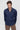 Man wearing navy blue slim fit long sleeve shirt and beige pants, front view