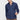 Man wearing a navy blue slim fit dress shirt and brown trousers on a plain background