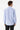 Man wearing a light blue slim fit dress shirt and black trousers, back view