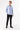 Man wearing blue slim fit shirt and black dress pants against white background