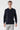 Men's navy long sleeve polo shirt, relaxed fit, modeled with light grey trousers