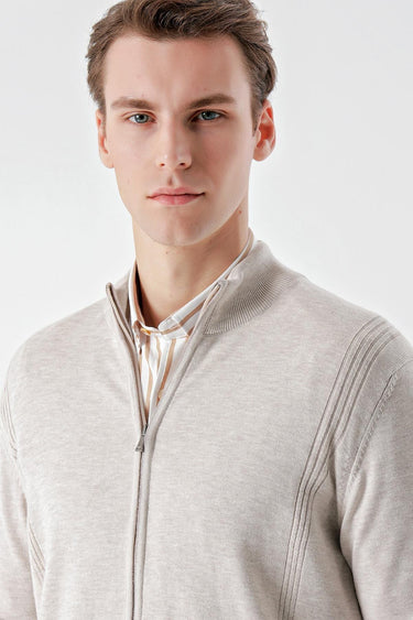 Man wearing a beige jacquard zip-up sweater with ribbed detailing