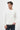 Man wearing a white basic crew neck long sleeve t-shirt and dark jeans