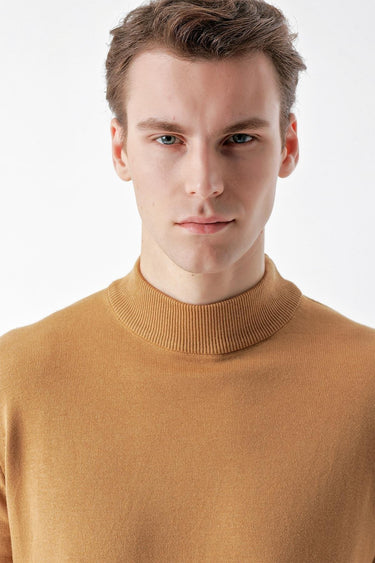 Man wearing camel basic half turtleneck sweater against white background