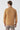 Man wearing camel brown long sleeve basic half turtleneck sweater, back view