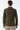 Back view of man wearing khaki slim fit woven blazer with buttoned cuffs and beige trousers