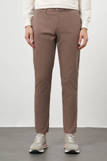 Men's brown slim fit cotton pants with side pockets, styled with sneakers