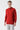 Man wearing a red basic half turtleneck sweater and light grey pants on white background