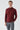 Man wearing a dark burgundy turtleneck sweater and gray plaid trousers