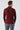 Man wearing a dark burgundy long sleeve sweater and grey plaid trousers, back view