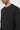 Close-up of man wearing a black crew neck long sleeve t-shirt, minimalist style