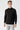 Man wearing a black basic half turtleneck sweater with long sleeves, light jeans, studio setting