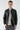 Man wearing black faux leather bomber jacket with zip details and grey jeans on white background