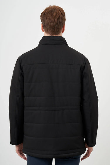 Rear view of a man wearing a black quilted long-sleeve jacket