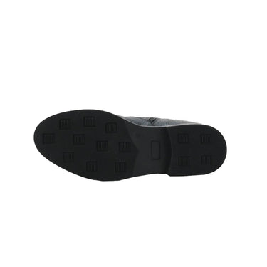 Black textured rubber sole of a men's fashion shoe with square grip pattern
