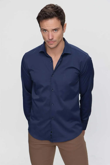 Man wearing navy blue slim fit long sleeve shirt and beige pants, front view