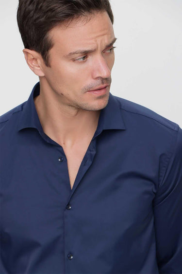 Man wearing navy blue slim fit dress shirt with spread collar